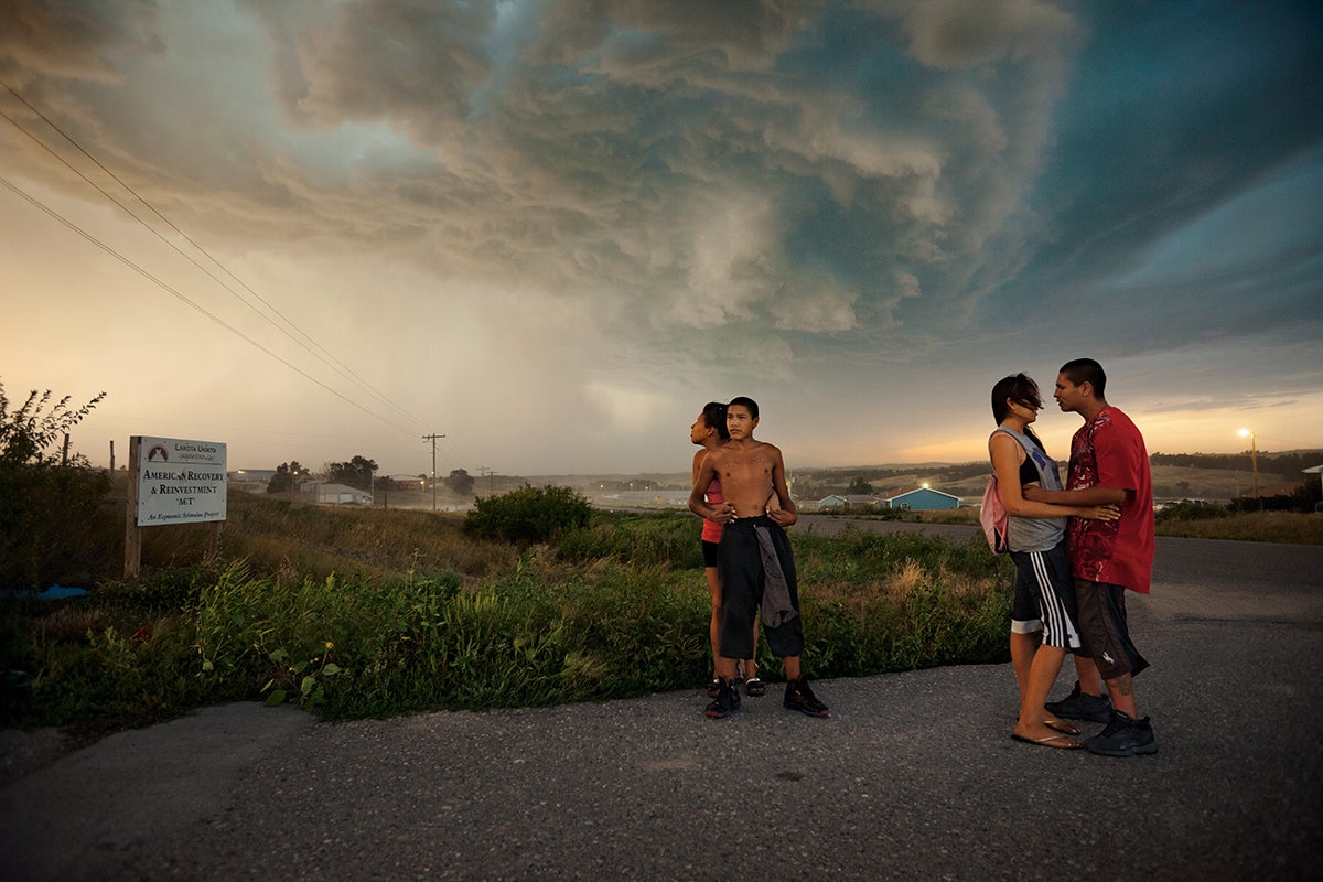 people standing on the side of the road in a Native American reservation