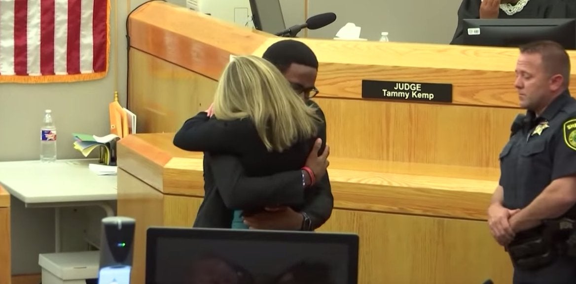 Brandt Jean embraces Amber Guyger, an ex-cop who has been convicted of murdering his brother, Botham Jean