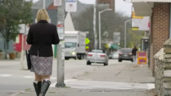 Woman featured in the documentary walking down the street