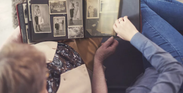 Two people looking at old pictures 