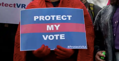 Person holding sign that reads "Protect My Vote" 