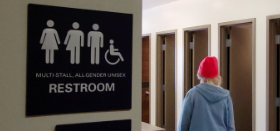 Person walking into gender neutral bathroom