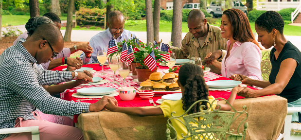 Photo of Black American Family Praying at Table