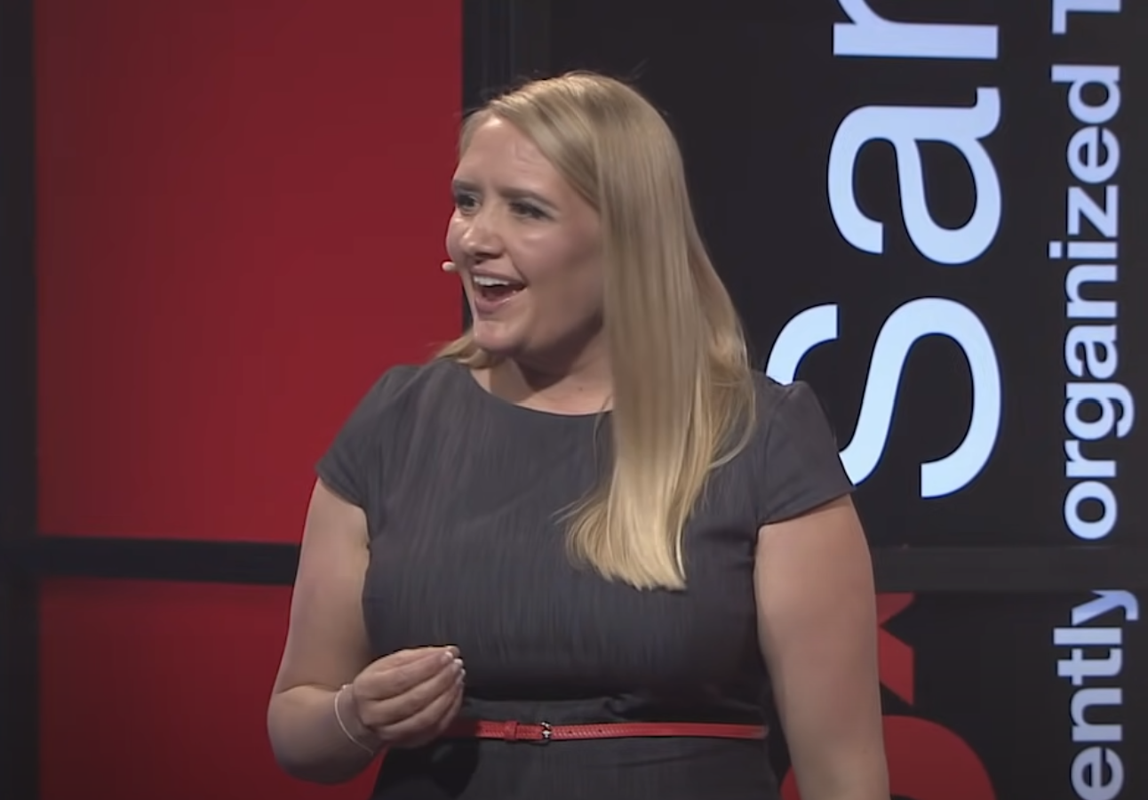 Woman speaking on TedX stage