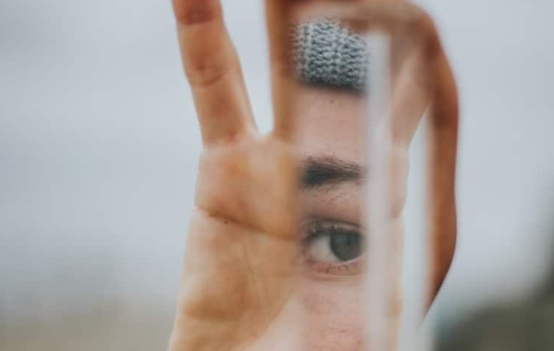 a mirror being held in somebody's hand