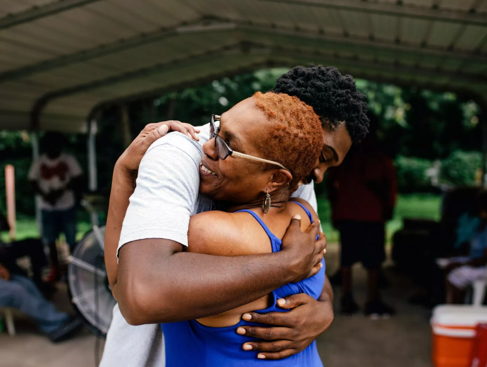 Man hugging his elderly mother