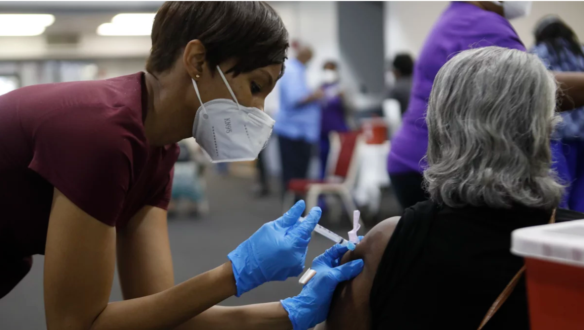 A Black woman receives a COVID-19 vaccine at a clinic in Tampa, Fla. Black Americans have died of the disease at a rate more than double that of white people.