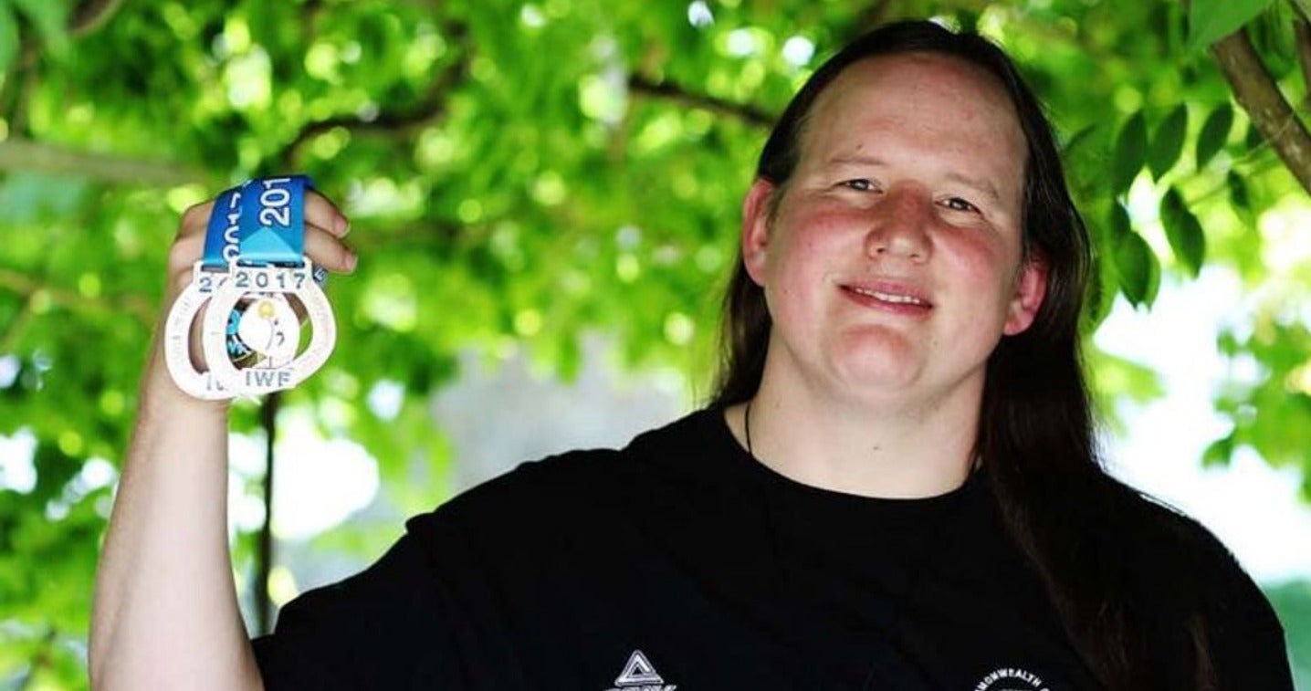 Laurel Hubbard holding up two medals 