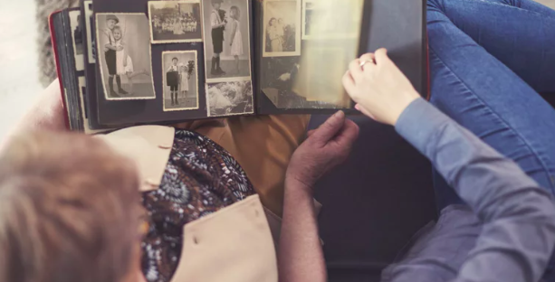 Two people looking at old pictures 