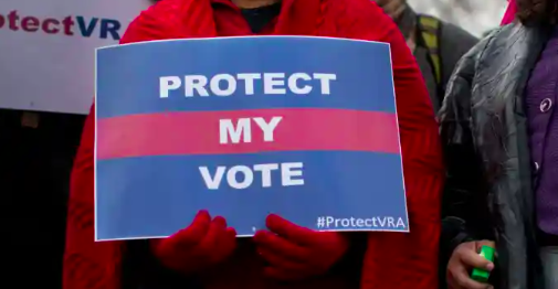 Person holding sign that reads "Protect My Vote" 