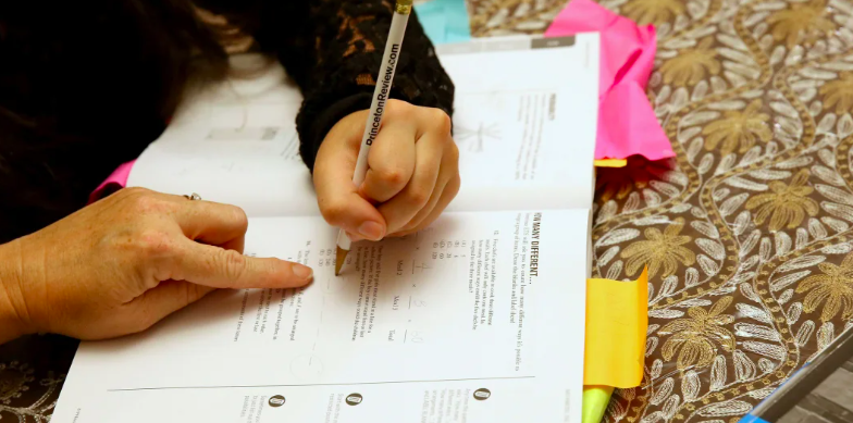 Person filling out college application testing 
