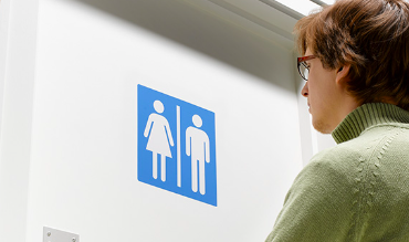 Person looking at gender sign 